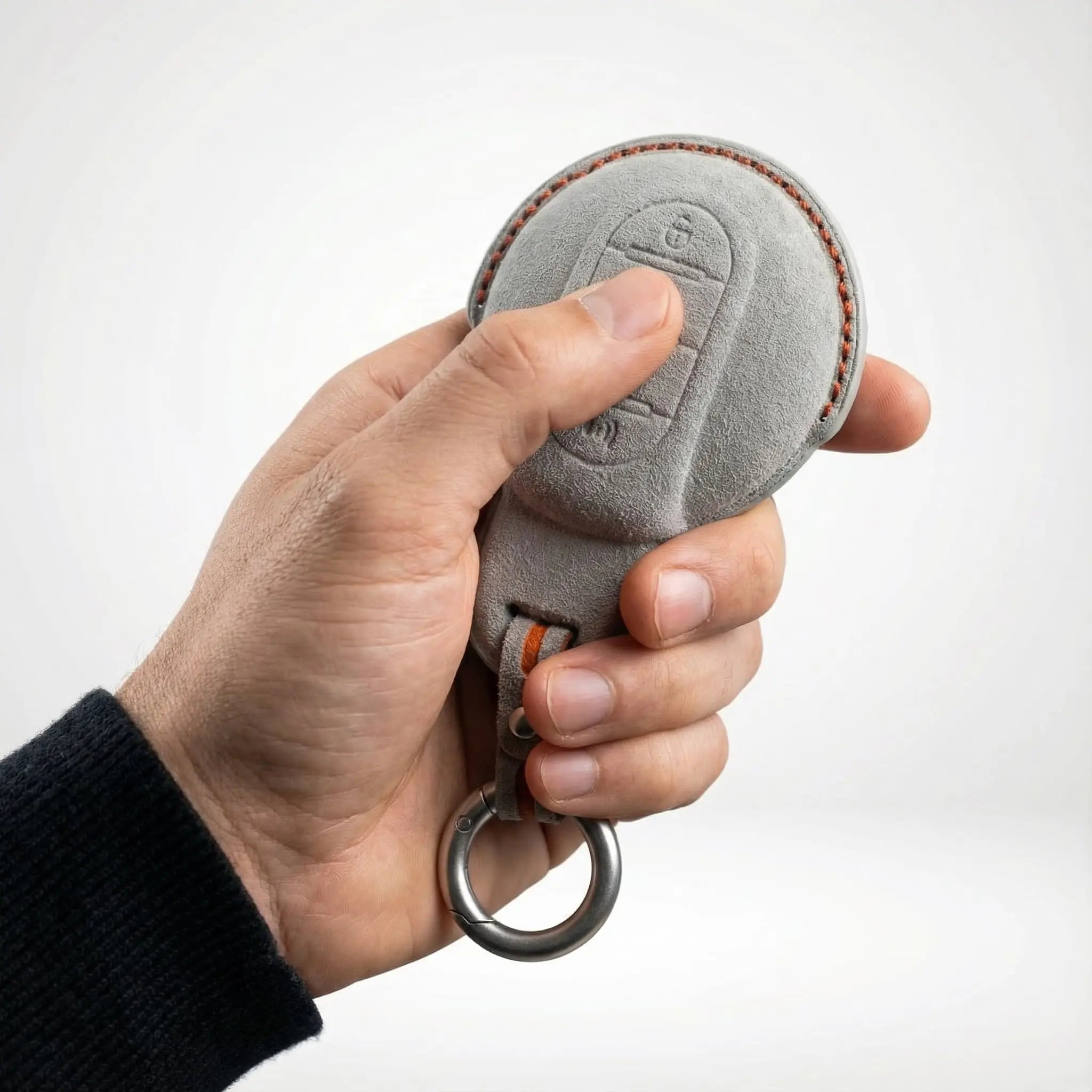 Hand holding Mini Cooper key cover Type A light grey Alcantara - suede key fob protection