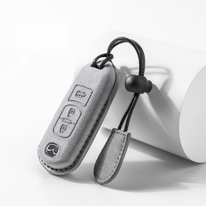 Grey Mazda suede key case with full button access
