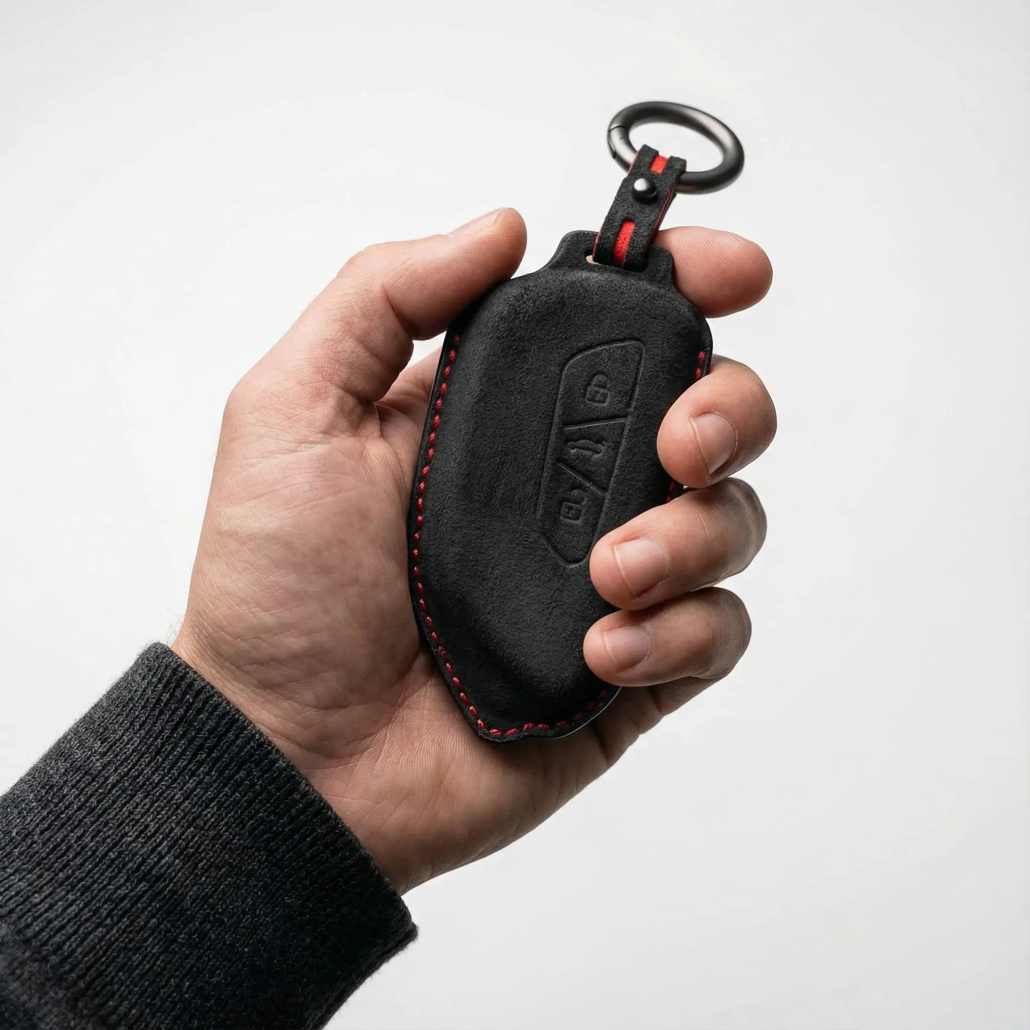 Volkswagen key cover black Alcantara suede with red stitching held in hand – VW key fob case Type A