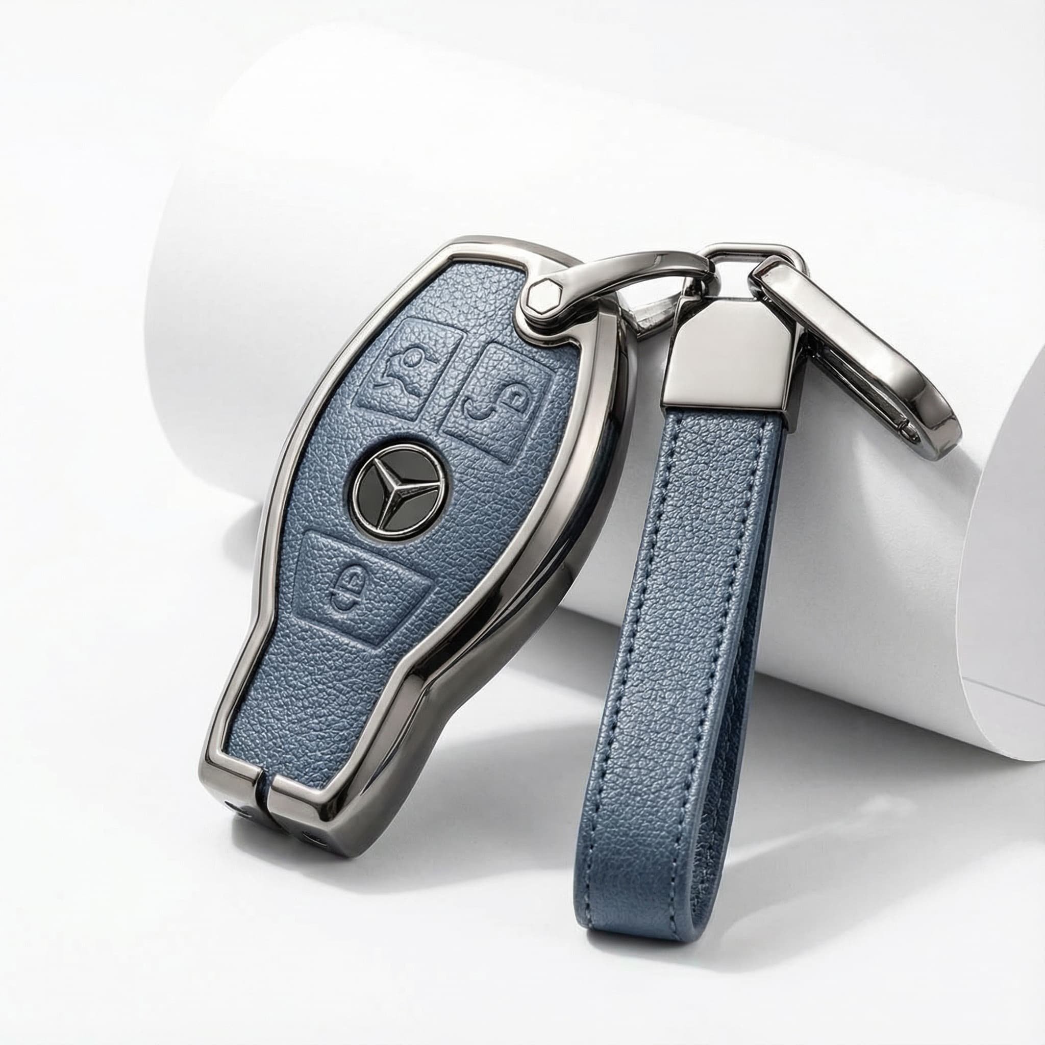 Mercedes-Benz key fob with blue leather strap on a white background