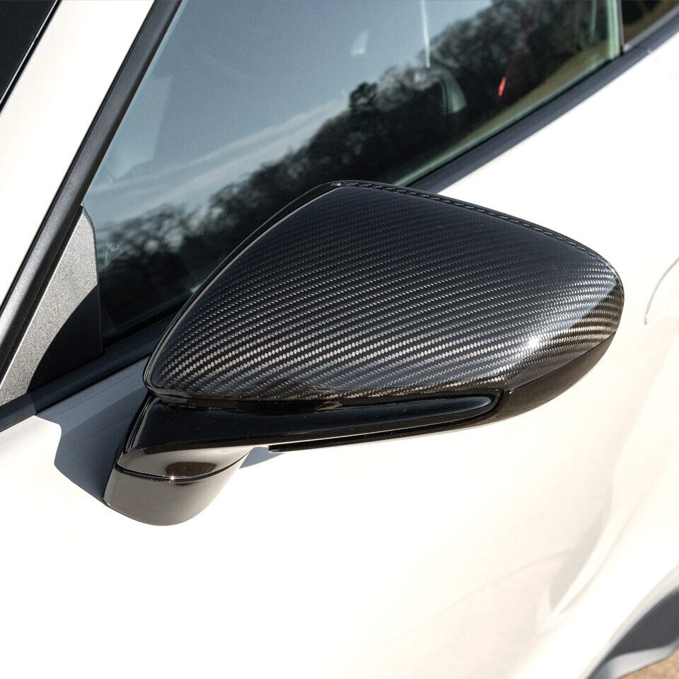 Carbon fiber mirror cap close-up on Porsche 911 992 – twill weave, gloss