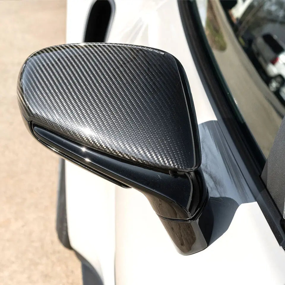 Left side carbon fiber mirror cap installed on Porsche 911 992