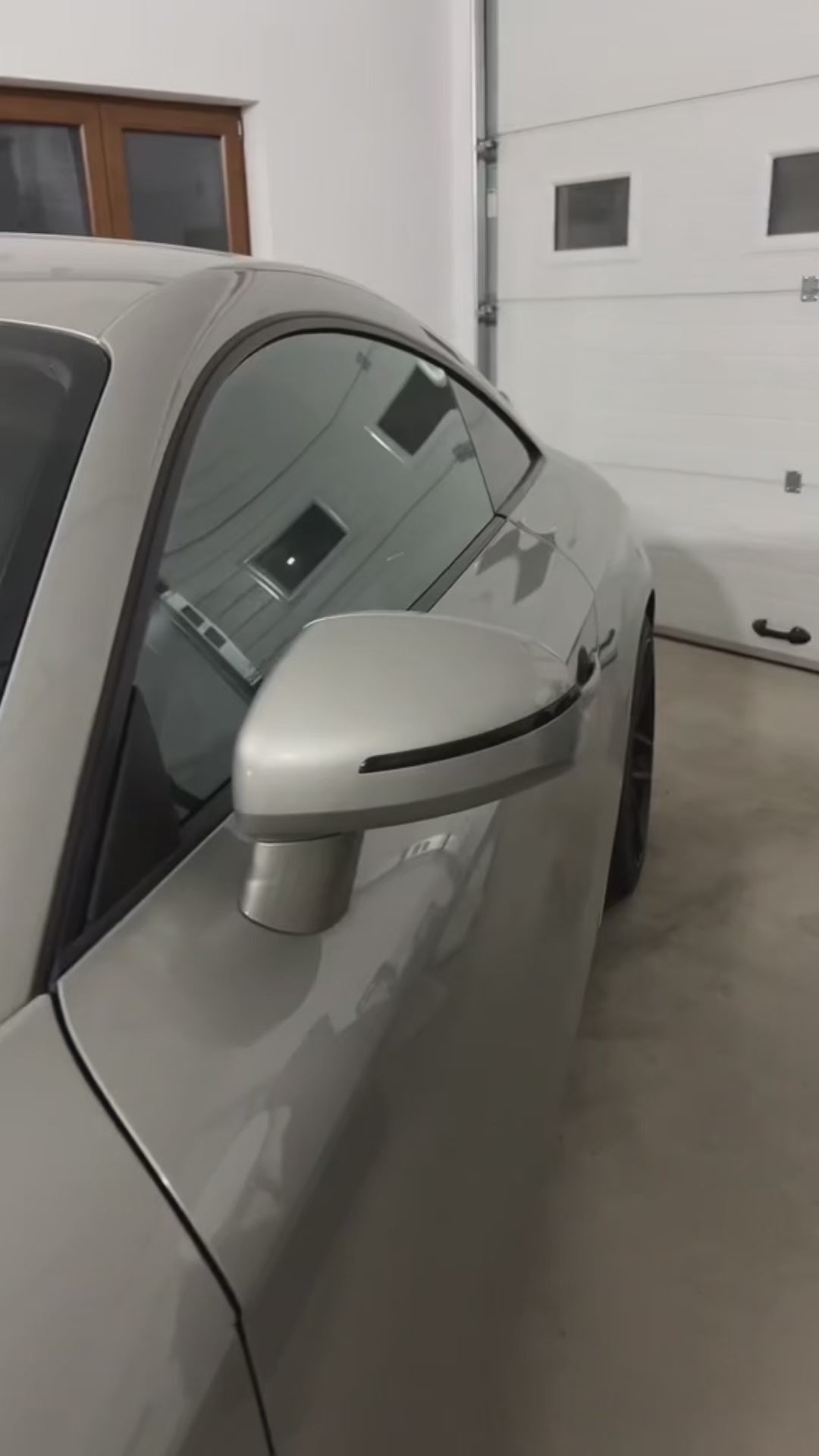 Close-up view of Audi dynamic turn signal mirror with LED lights.