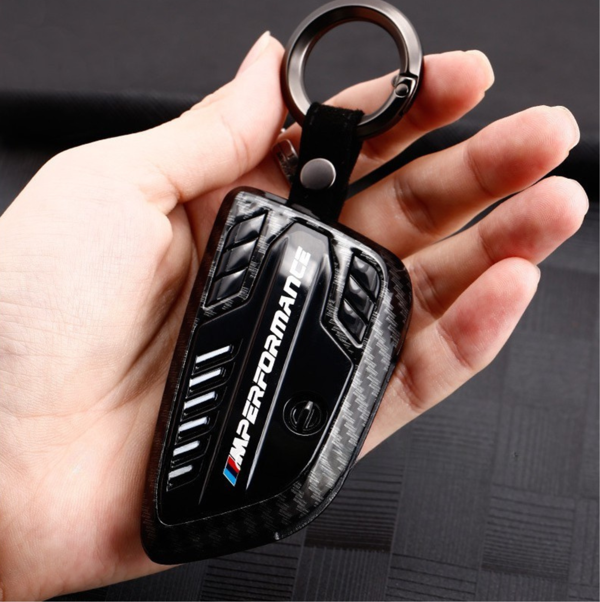 BMW Carbon Fiber key cover shown in hand with keyring