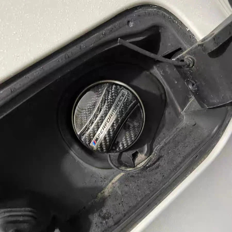 BMW carbon fiber fuel cap installed on a vehicle, providing a sporty and high-end aesthetic with durable carbon fiber construction.