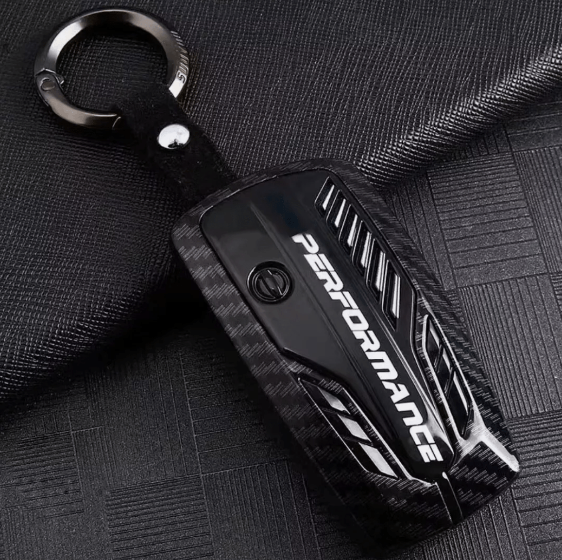 BMW carbon fiber key cover featuring a stylish key ring attachment, designed for durability and a high-end performance aesthetic.