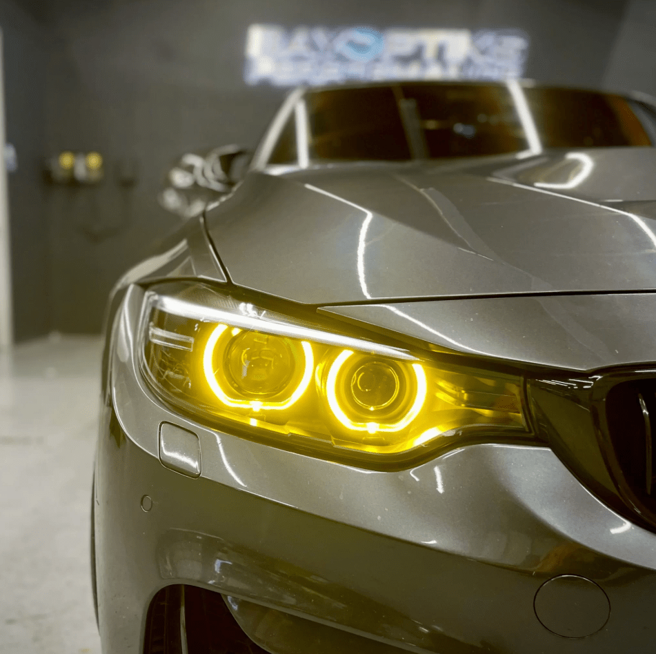 BMW F30 Pre-LCI CSL yellow DRL module upgrade illuminating in dark, giving a bold, aggressive look to 2012-2015 3 Series Xenon headlights.