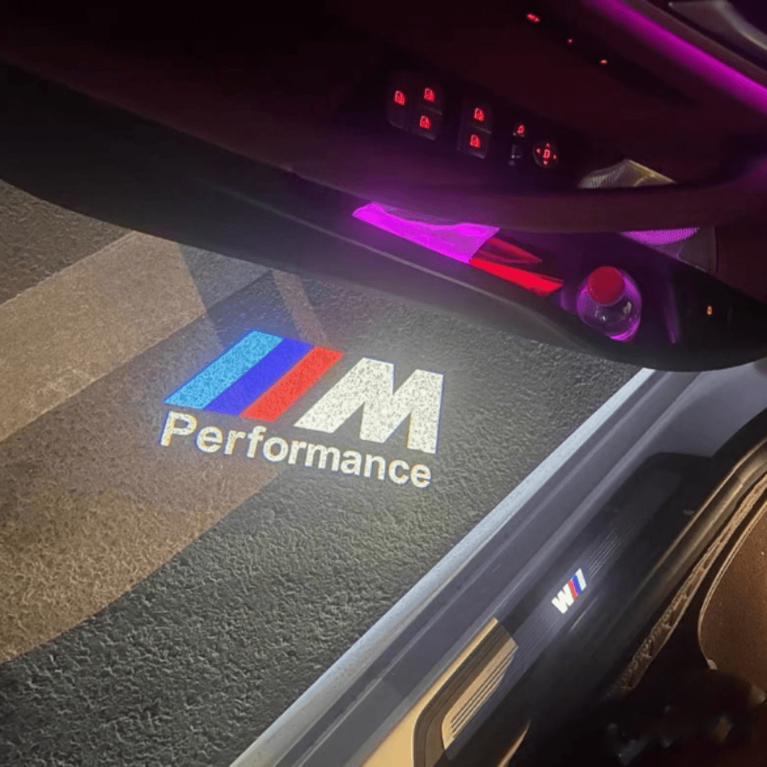 BMW M performance LED door 
logo projector installed on the door, showcasing a bright and sharp logo projection on the ground for an enhanced entry experience.