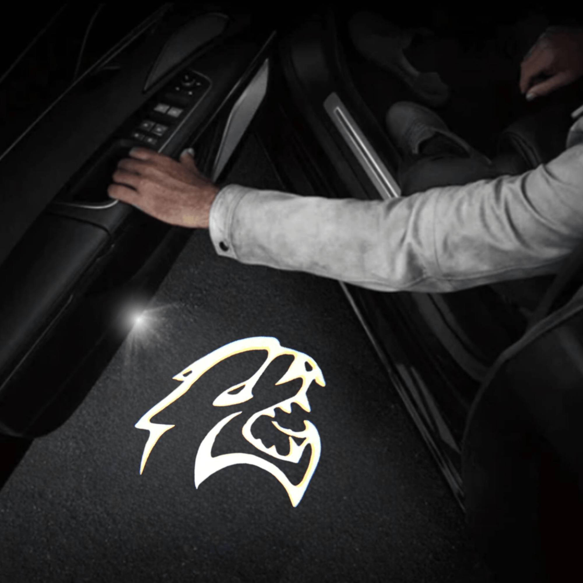 Dodge LED door projector light displaying the Hellcat logo on the ground, enhancing the vehicle entry with a bold and aggressive illuminated effect