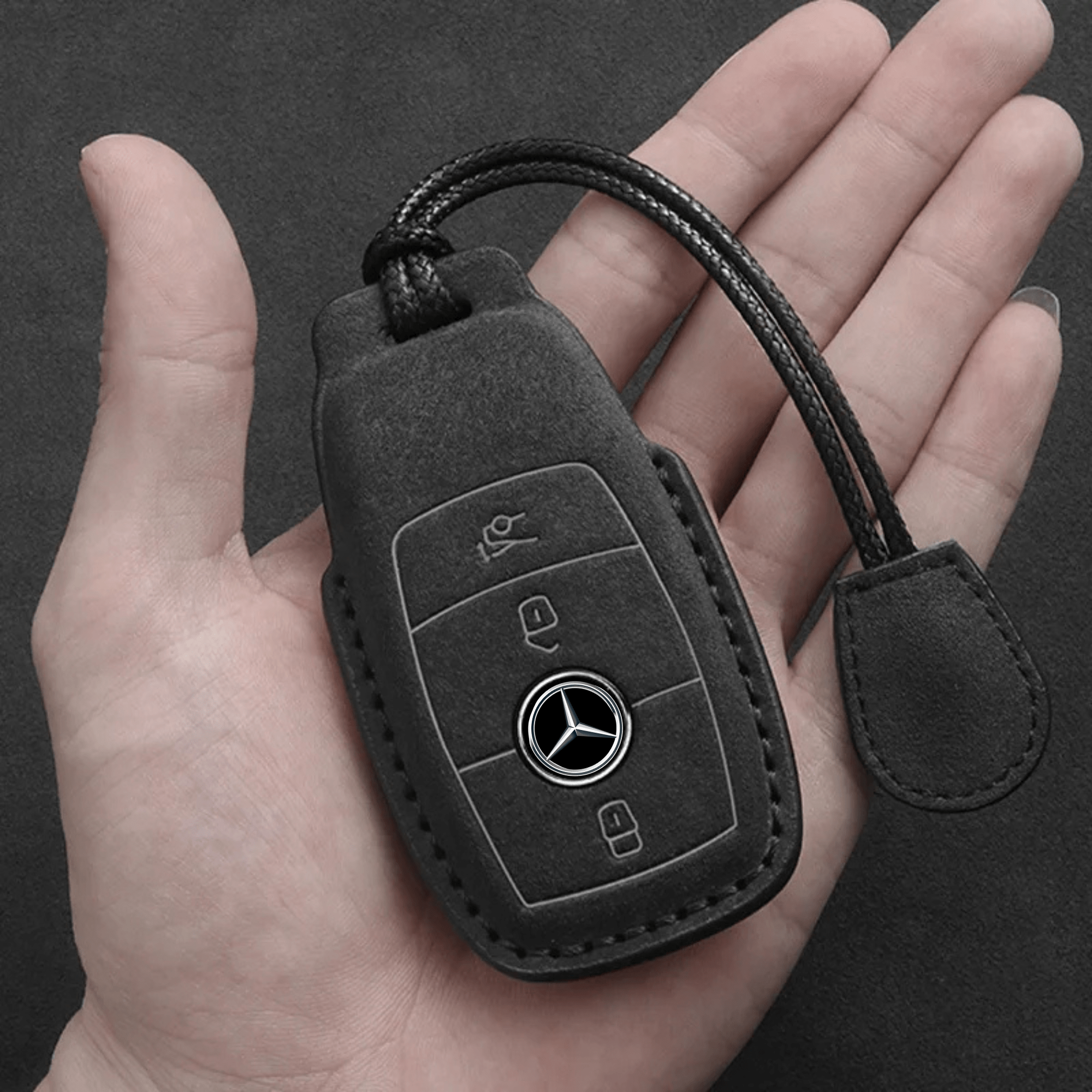 Mercedes-Benz Alcantara key cover held in hand, demonstrating the luxurious suede texture and perfect fit for the key fob.