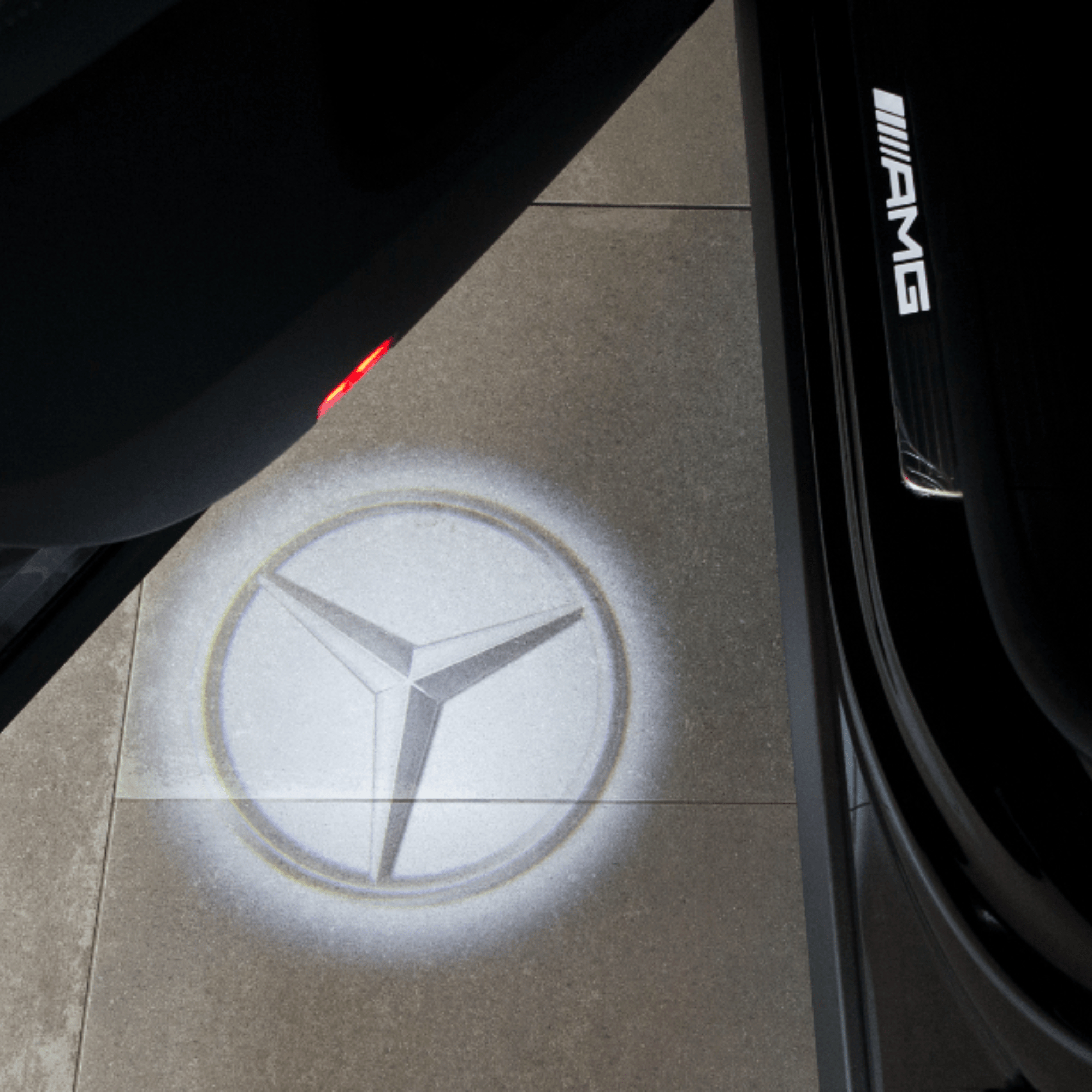 Mercedes-Benz LED door projector light displaying the classic star logo on the ground, enhancing vehicle entry with a premium illuminated effect.