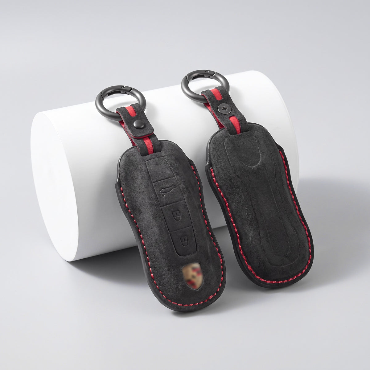 Front and back of the Alcantara Porsche key cover with red stitching