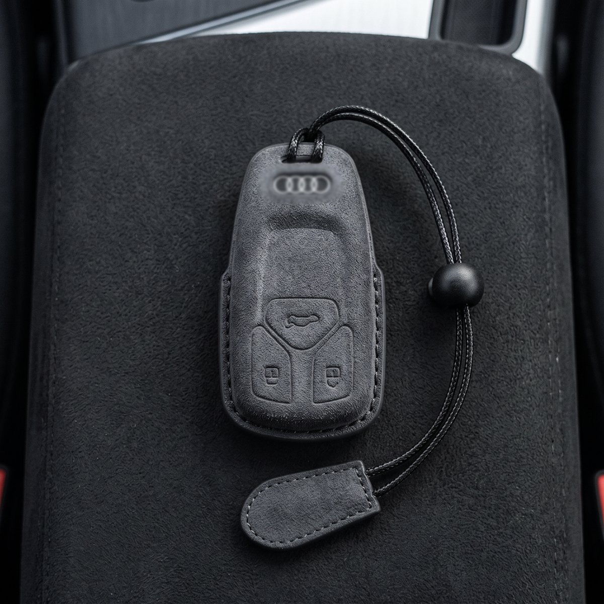 Grey suede Audi key cover top-down showing precise button cutouts